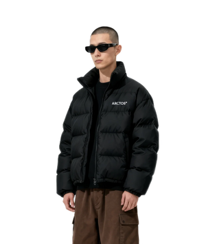 Person wearing a black puffer jacket with 'Arctos' branding on a white background