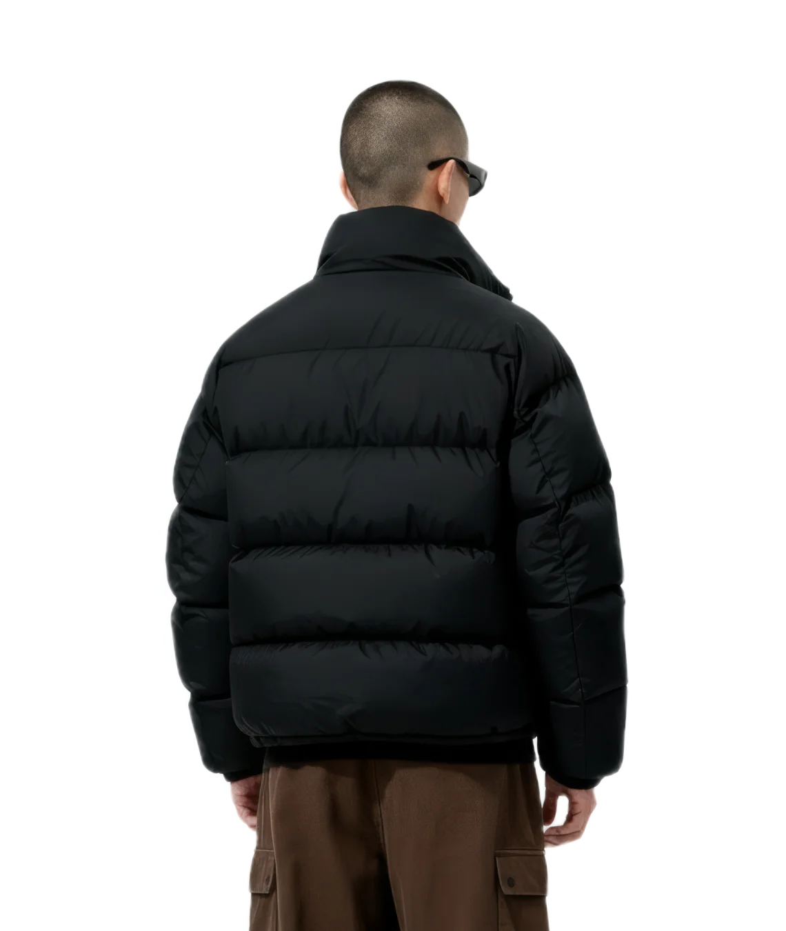 Person wearing a black puffer jacket on a white background