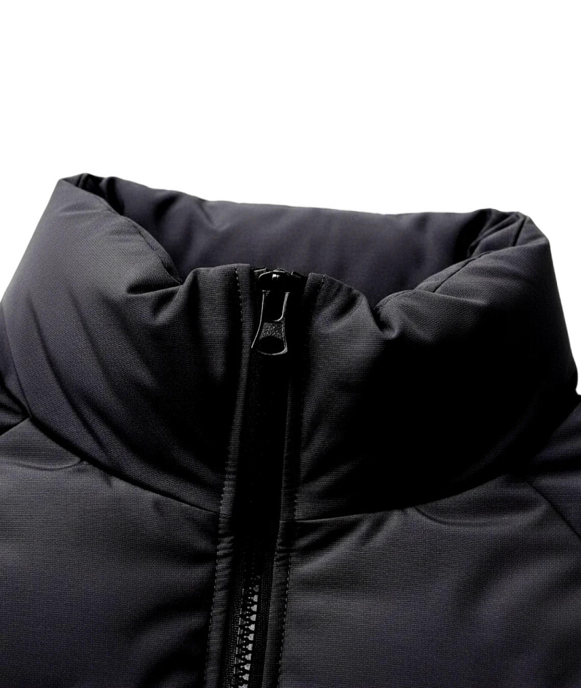 Close-up of a black puffer jacket with a zipper on a white background