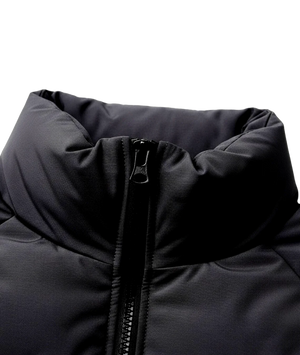 Close-up of a black puffer jacket with a zipper on a white background