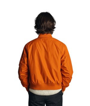 Person wearing an orange jacket on a white background
