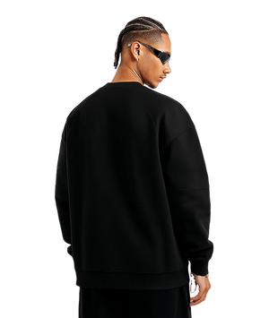 Person wearing a black sweatshirt on a white background