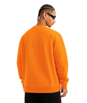 Person wearing an orange sweatshirt on a transparent background