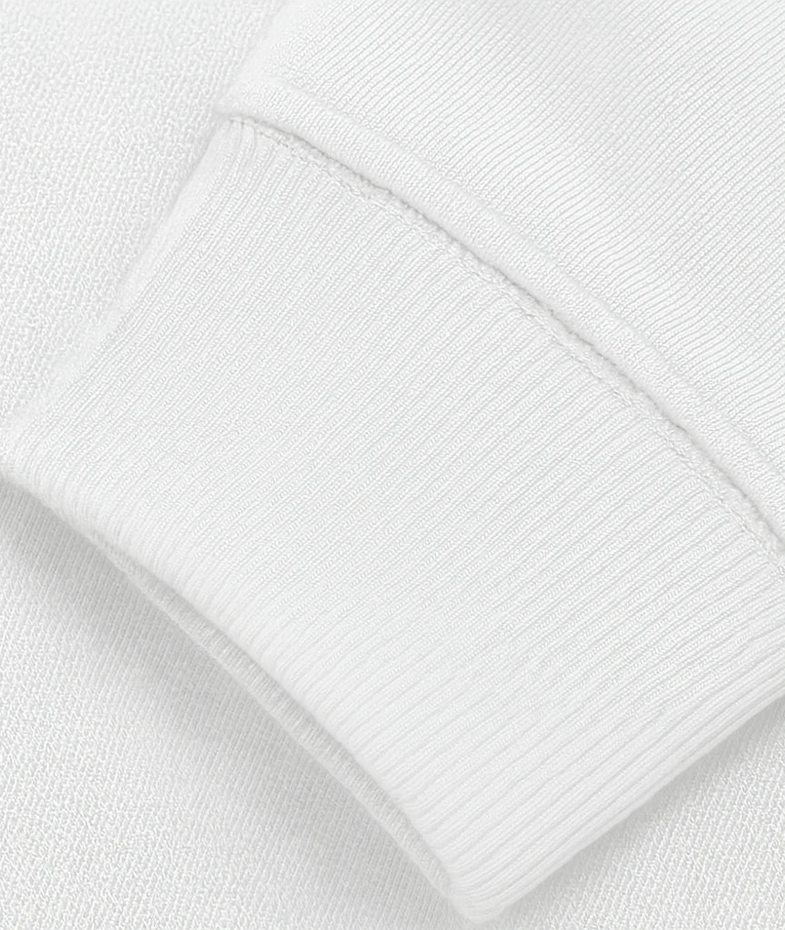 Close-up of a white textured fabric with a pocket detail