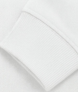 Close-up of a white textured fabric with a pocket detail