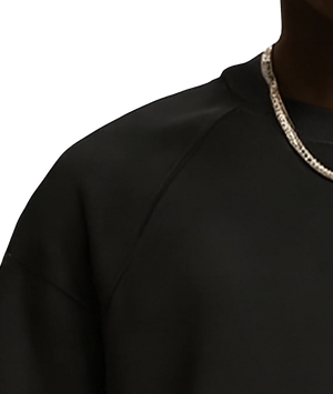 Black garment with a patterned neckline on a white background