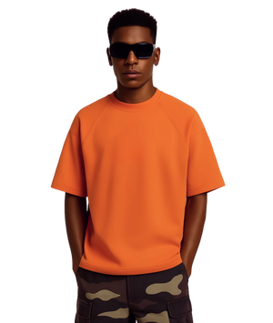 Person wearing an orange t-shirt and camouflage pants on a white background