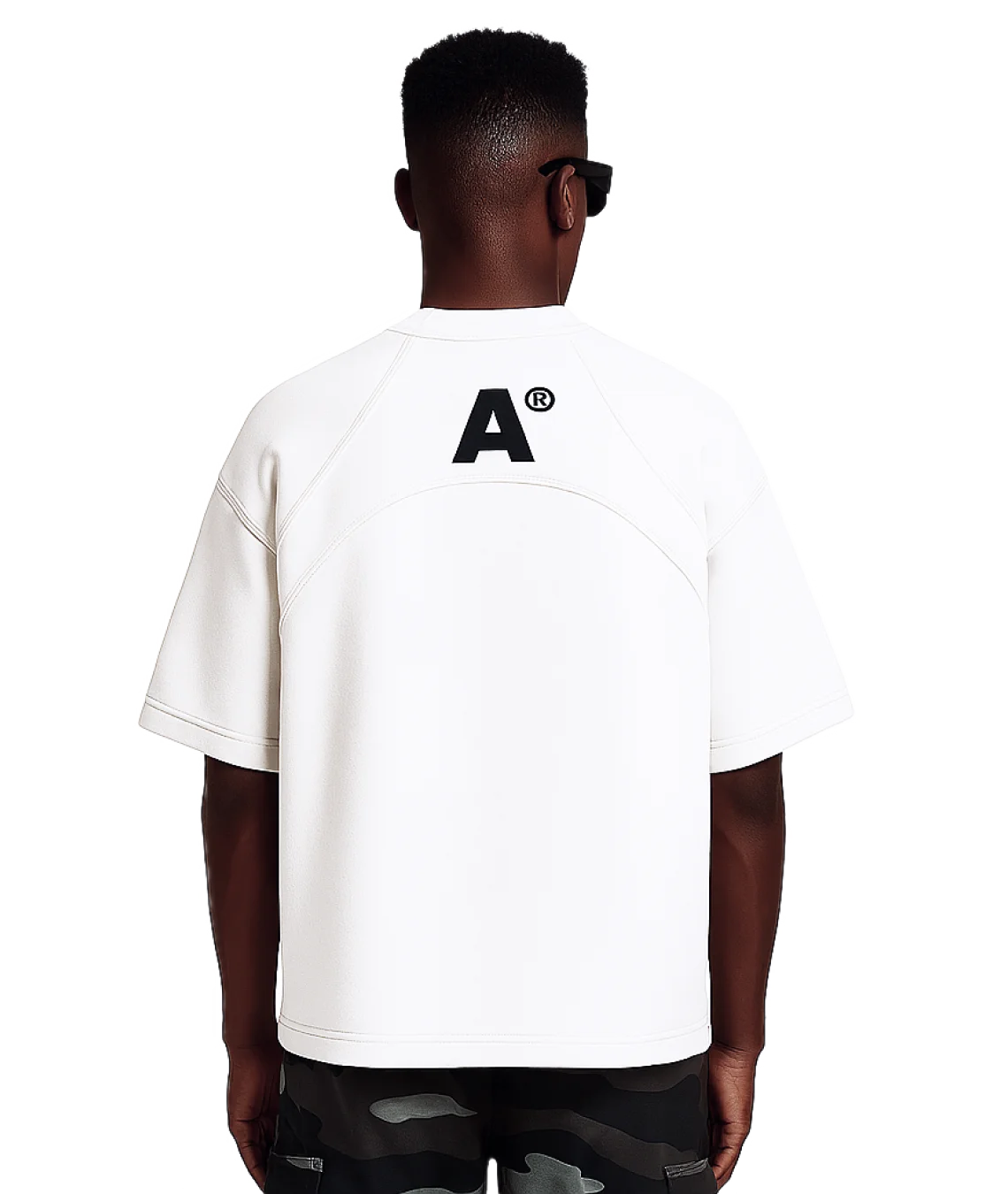 Person wearing a white t-shirt with a logo on the back, standing against a white background