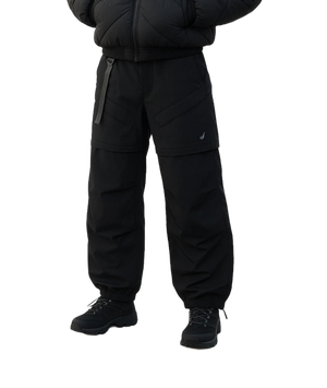 Person wearing a black snowsuit on a white background