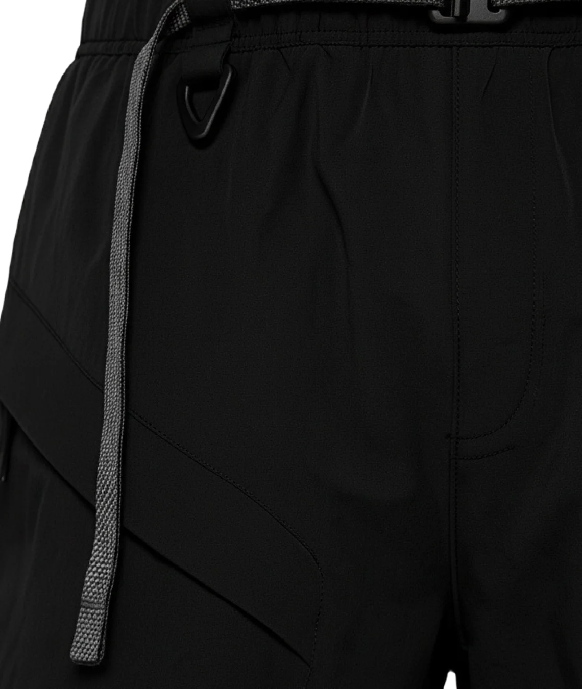 Close-up of black pants with a drawstring and belt buckle.