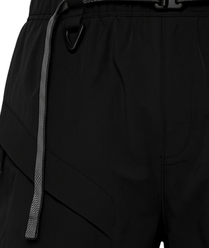 Close-up of black pants with a drawstring and belt buckle.