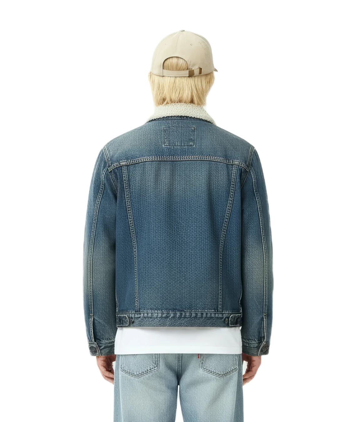 Person wearing a blue denim jacket and light-colored cap on a white background