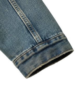 Close-up of rolled-up blue denim jeans on a white background