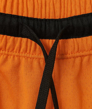 Close-up of orange pants with black waistband and drawstring