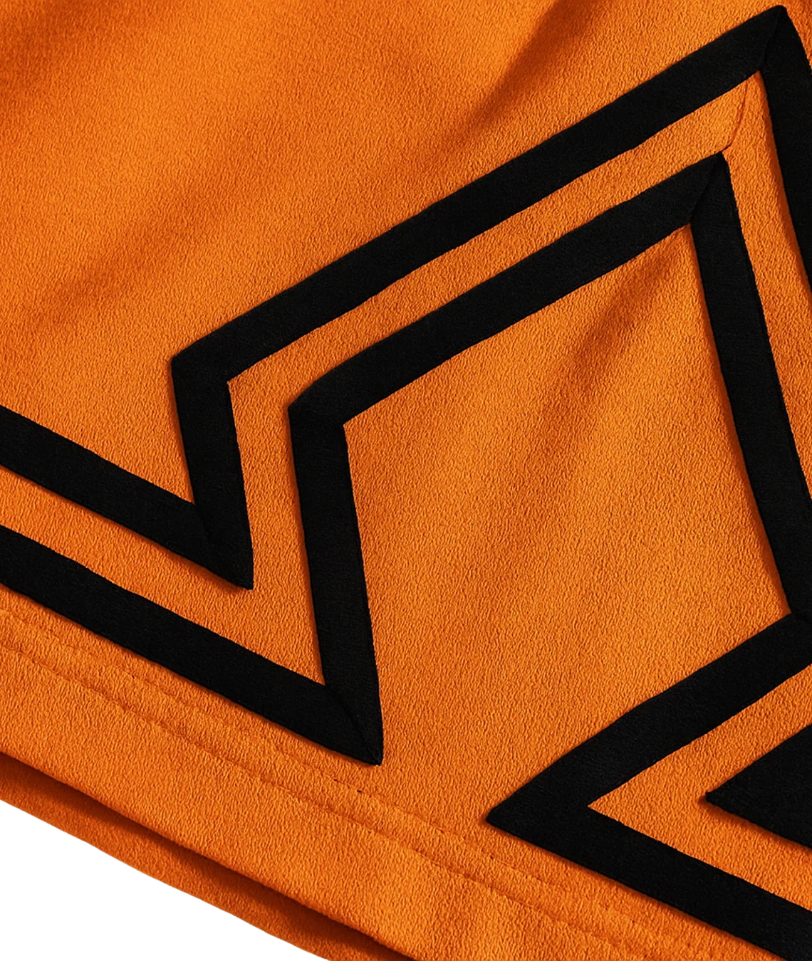 Close-up of orange fabric with black geometric patterns