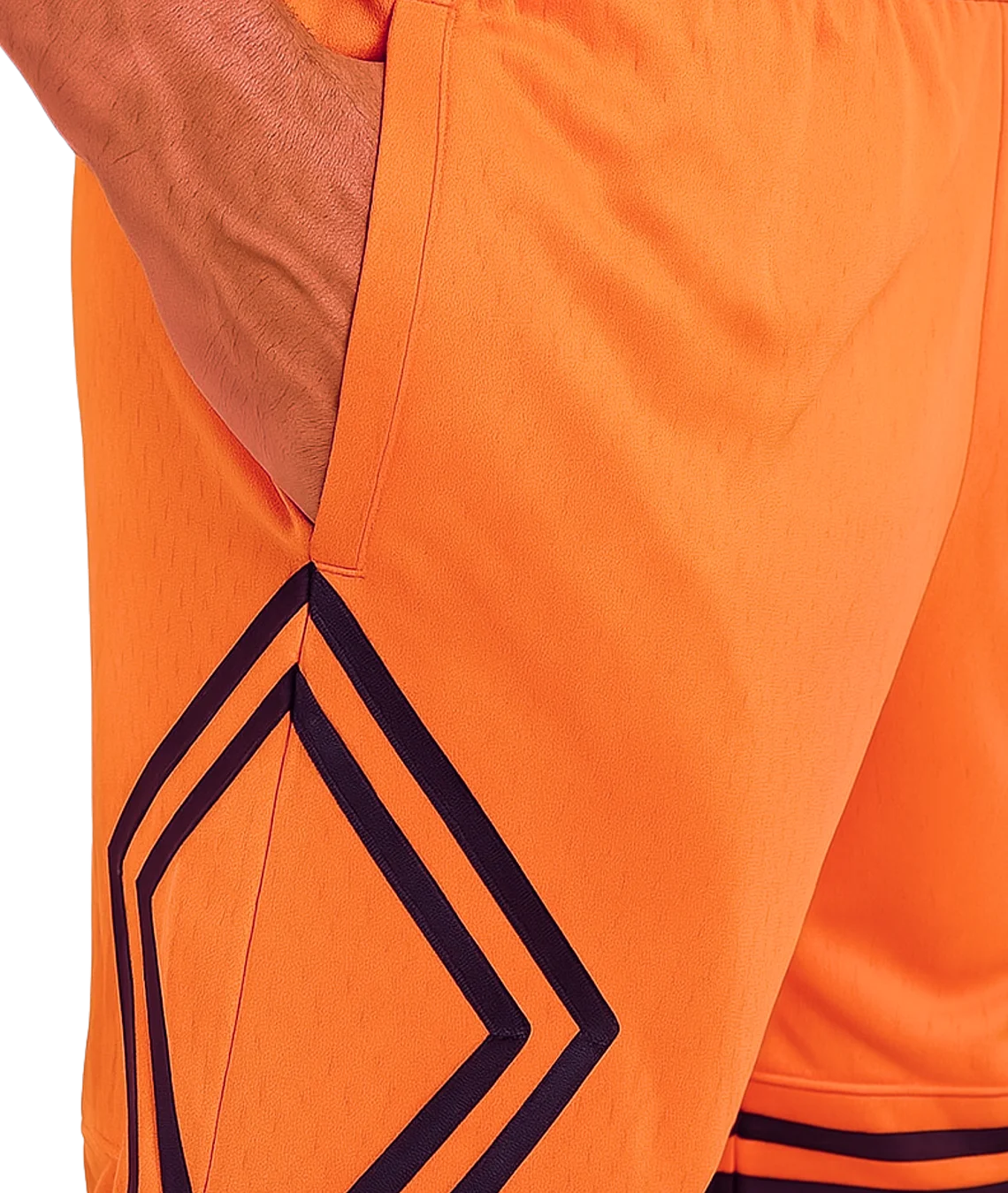 Close-up of orange shorts with geometric black pattern
