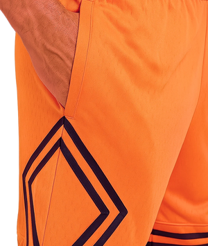 Close-up of orange shorts with geometric black pattern