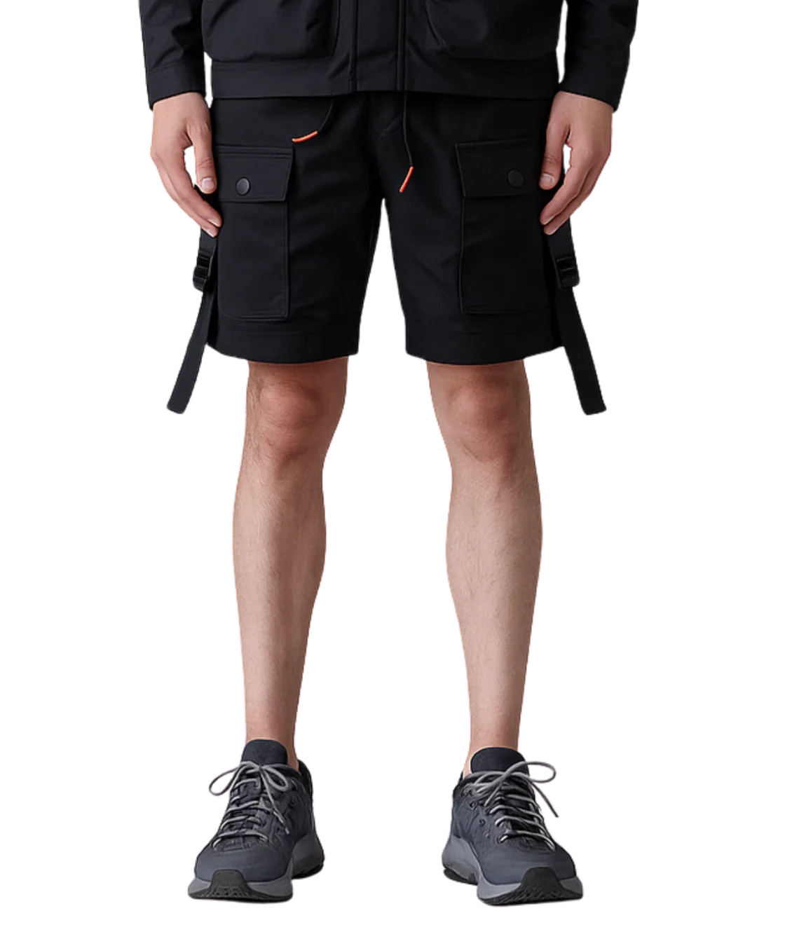 Person wearing black cargo shorts with orange accents on a white background