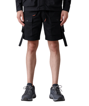 Person wearing black cargo shorts with orange accents on a white background