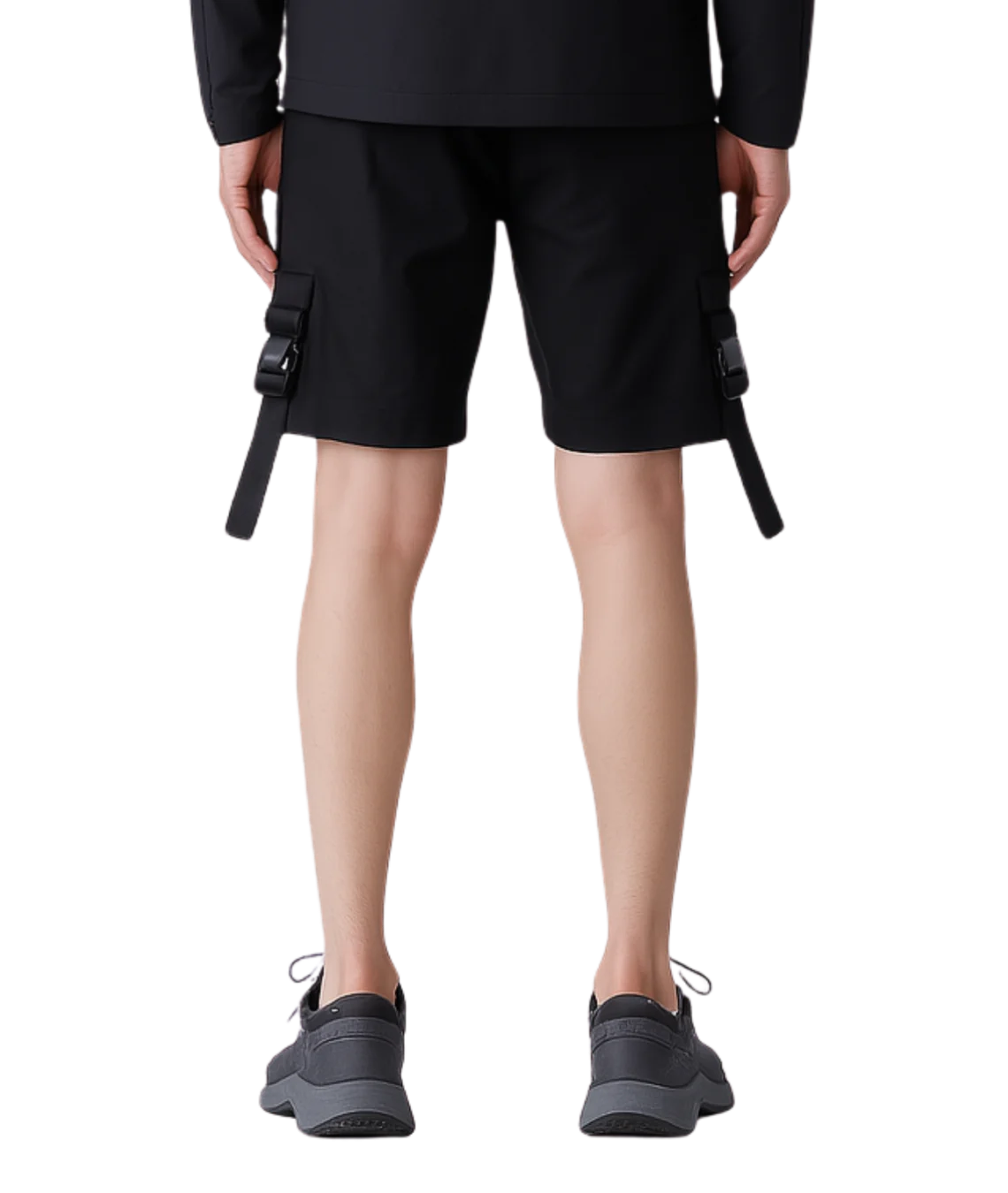 Person wearing black cargo shorts with a plain background