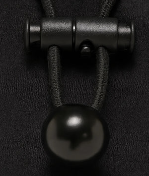 Close-up of a black metal clasp on dark fabric