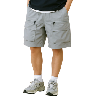 Person wearing light gray cargo shorts with decorative trim on a transparent background