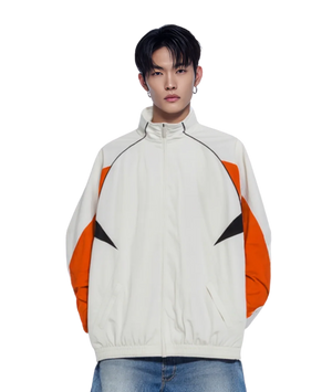 Person wearing a white jacket with orange and black accents on a white background