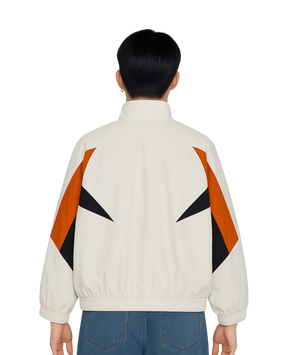 Person wearing a white jacket with orange and black geometric patterns on a white background