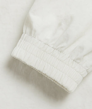 Close-up of a white textured fabric edge on a light background