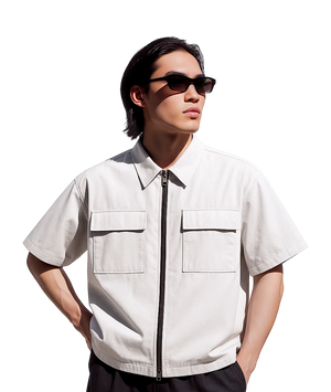 Person wearing a white short-sleeve shirt with zippers on a white background