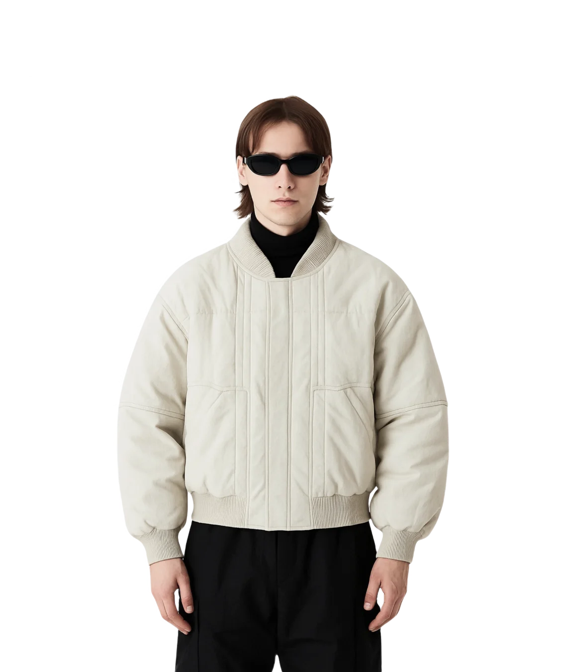 Person wearing a beige jacket and sunglasses on a white background